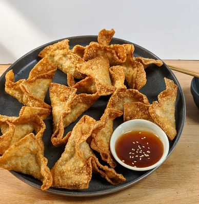 Crispy meat wontons with dipping sauce from Lucky Koi Express